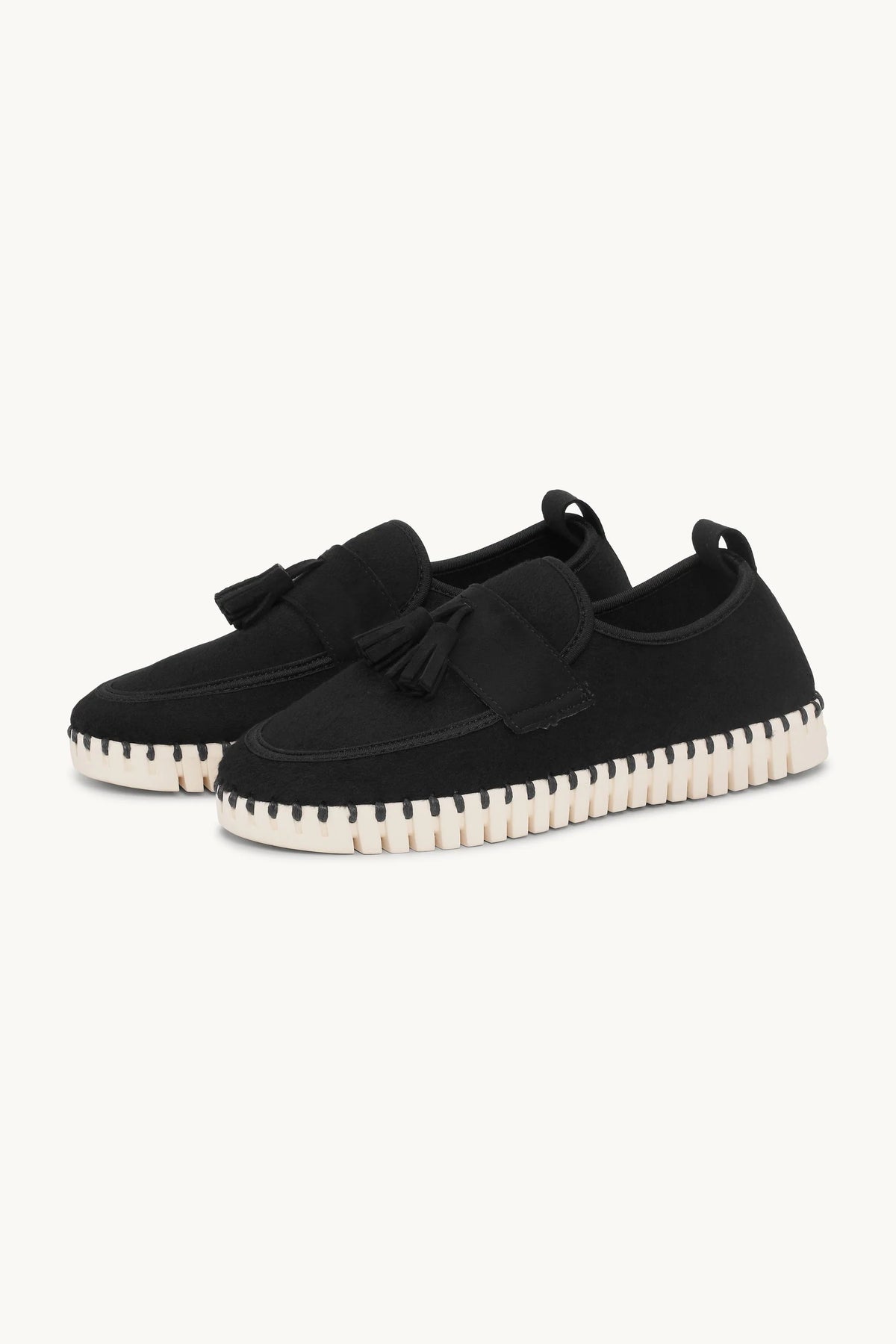 pair of wool black loafer with white sole on a plain background. 