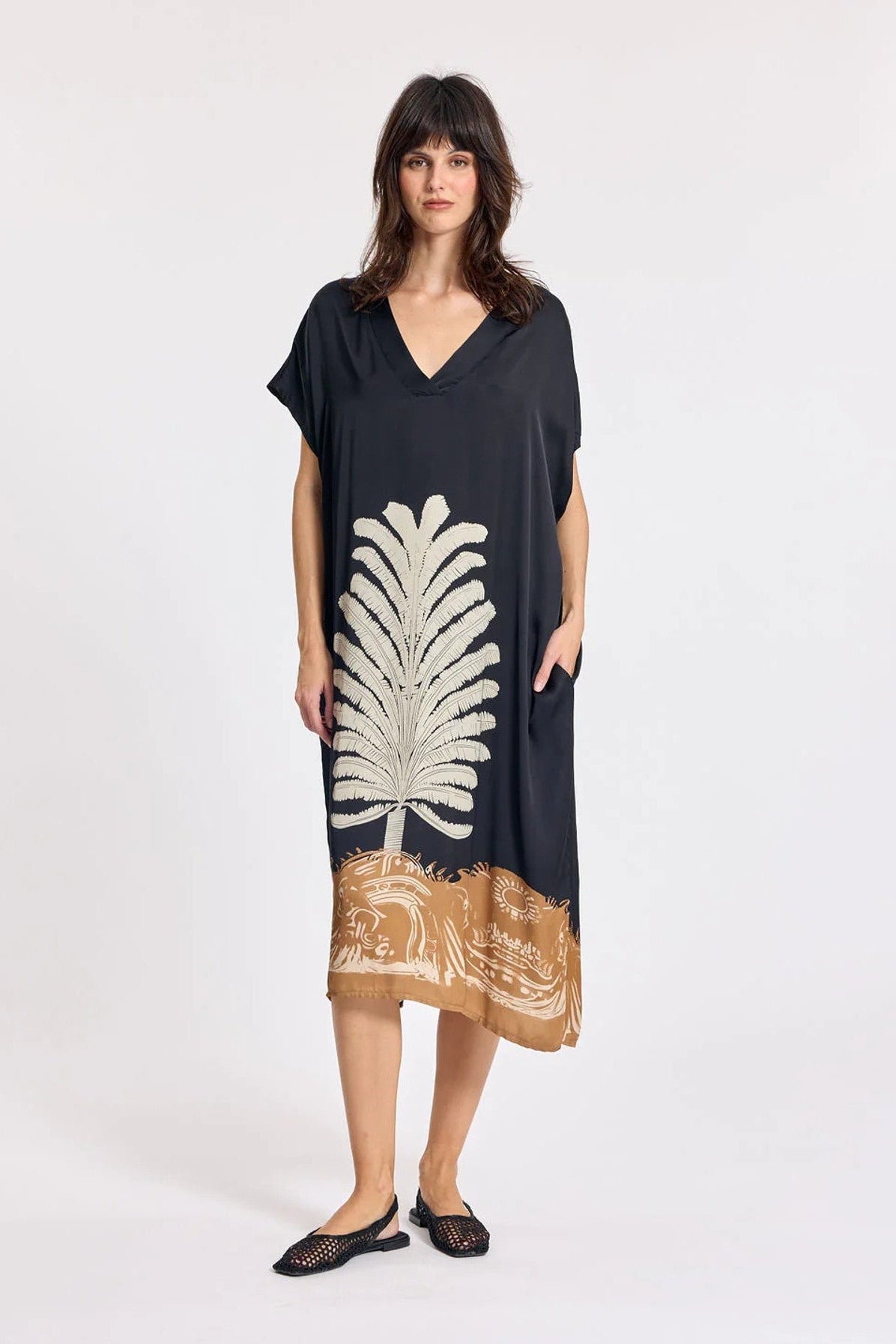 Women wearing navy short sleeve dress with front print. 