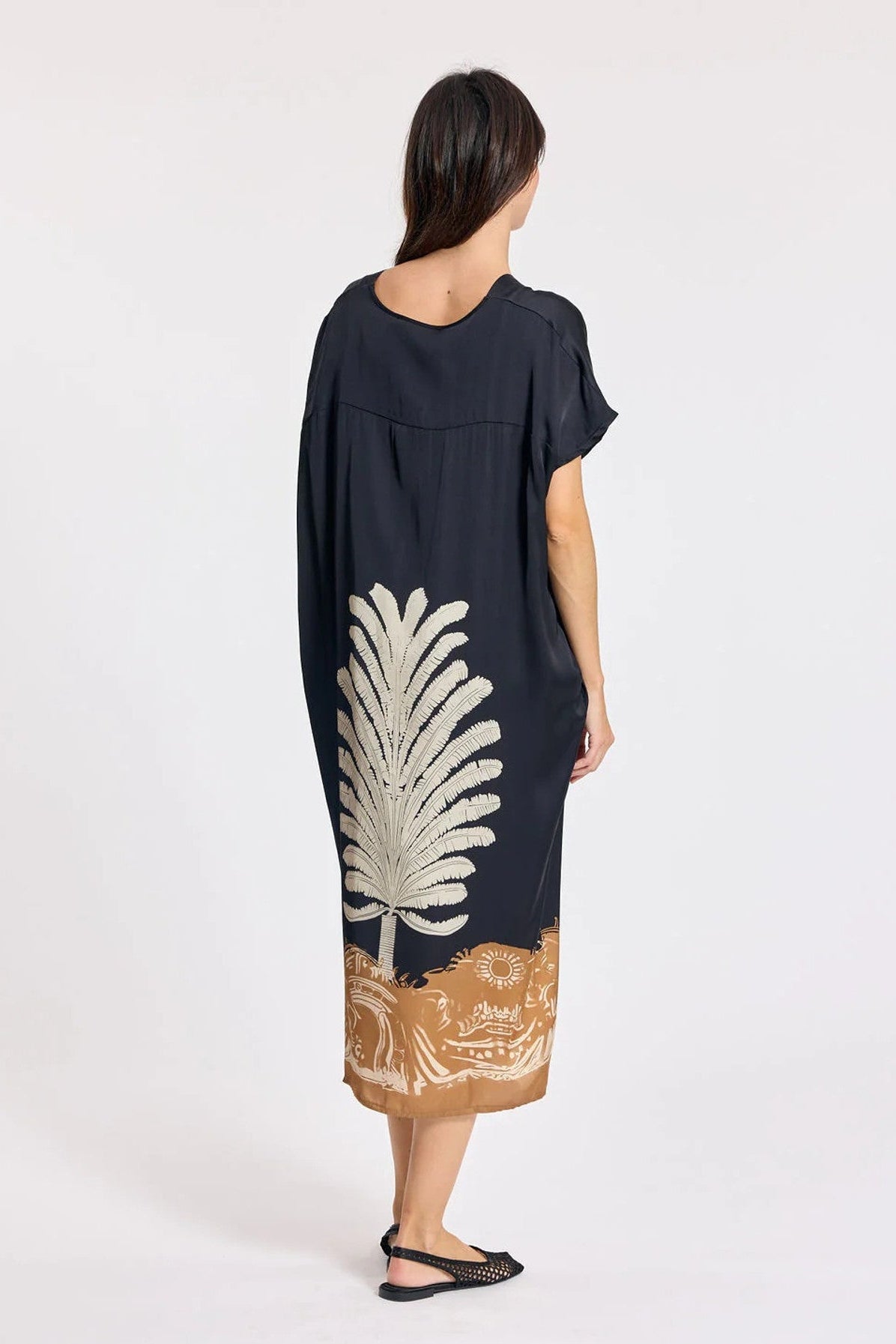 Women wearing navy short sleeve dress with front print. 