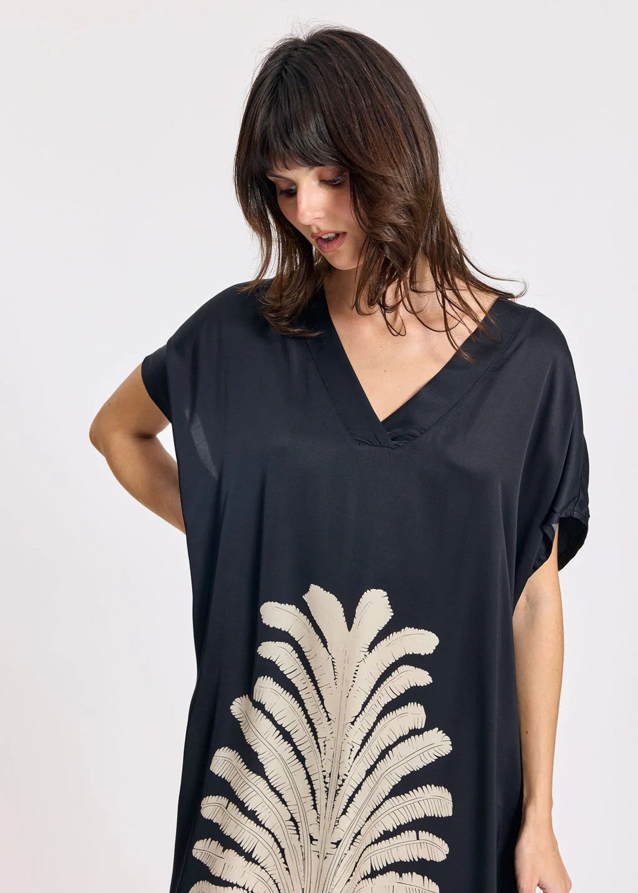 Women wearing navy short sleeve dress with front print. 