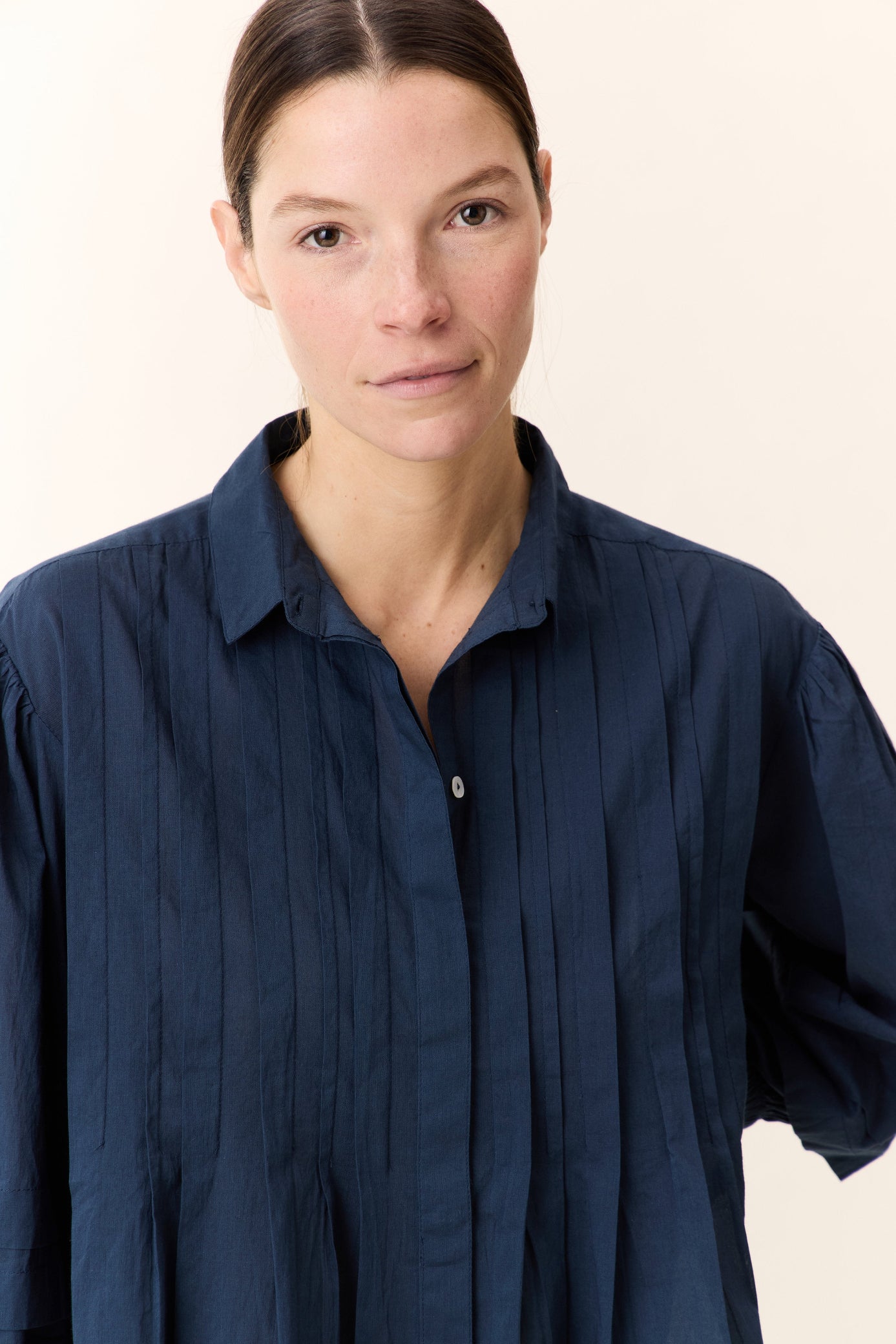Model wearing a Navy blue  frill short sleeve shirt on a white background