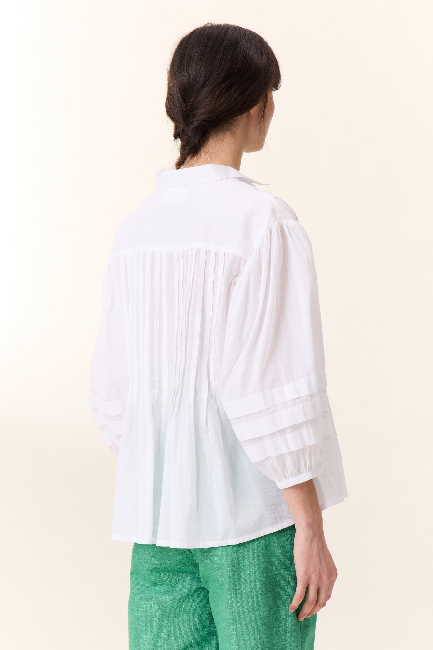 white short sleeve shirt with frill detail on a white background 