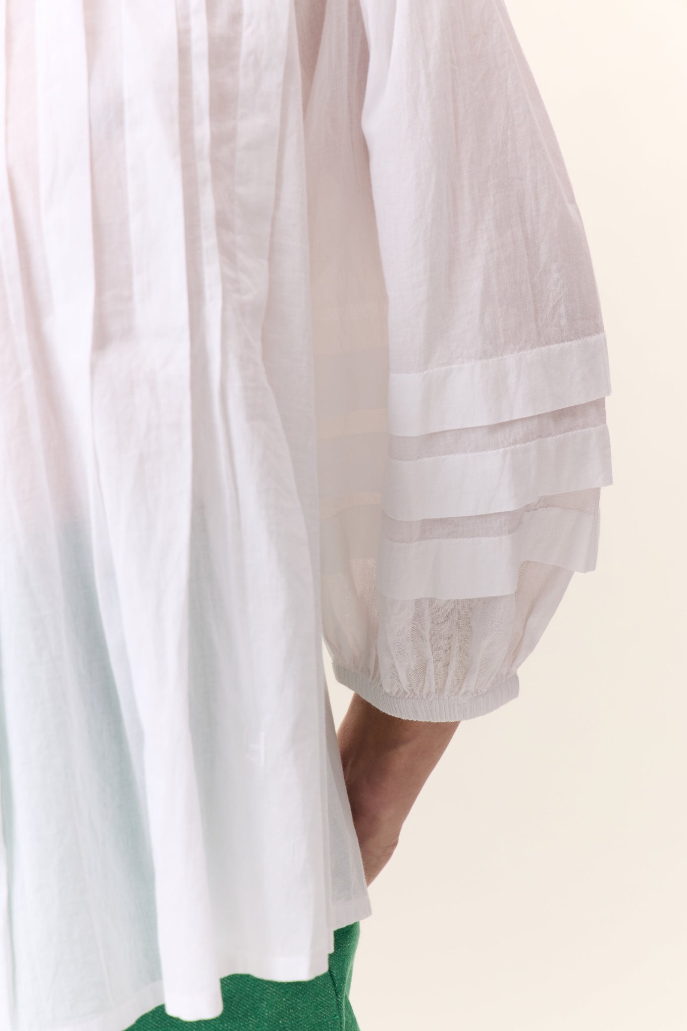white short sleeve shirt with frill detail on a white background 