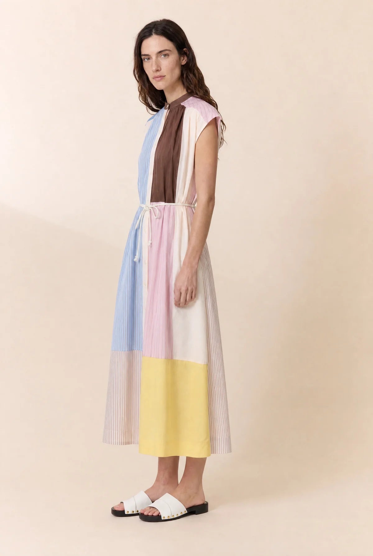 Woman wearing a colorful dress with a plain background