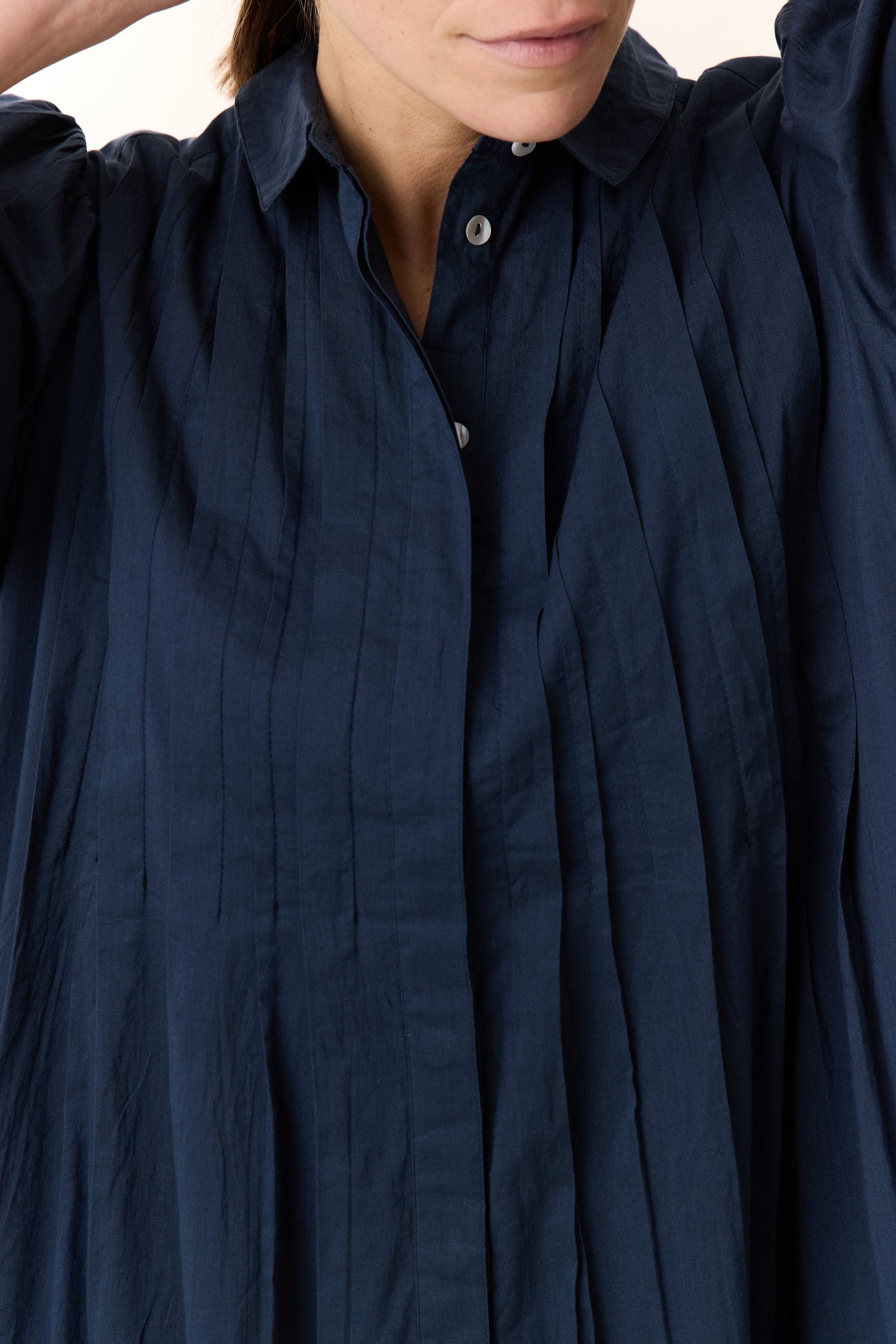 Navy blue dress with puff sleeves on a white background