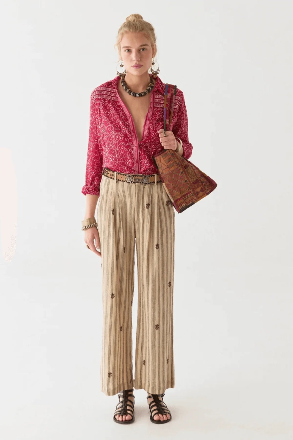 Woman wearing a red and white floral patterned shirt with a white background