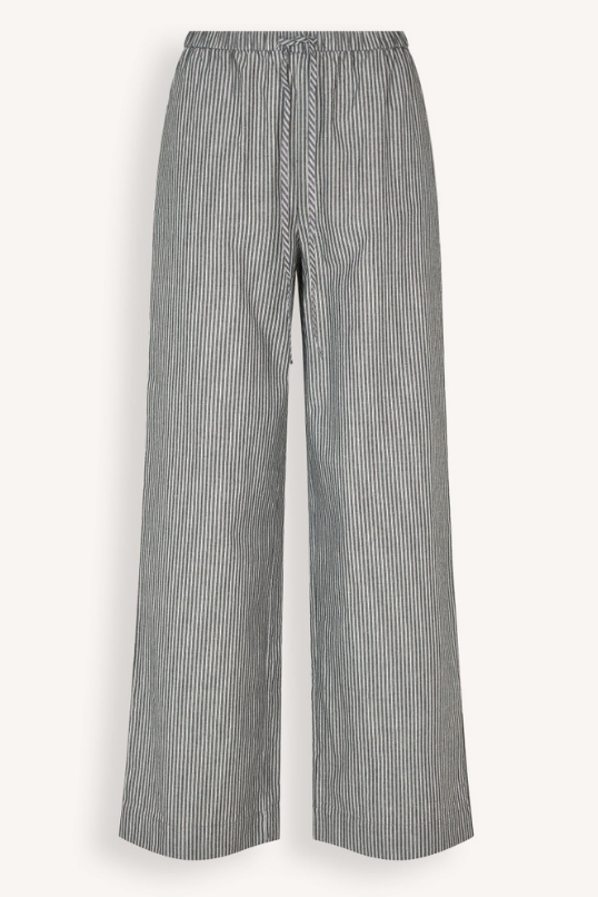 Washed black and white vertically striped wide-leg trousers with an elastic drawstring waist, shown against a plain off-white background.