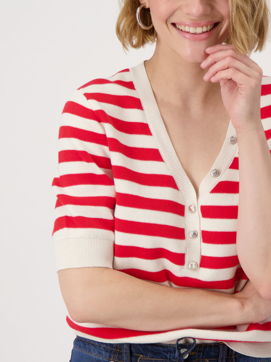 Woman wearing a red and white striped shirt on a plain background