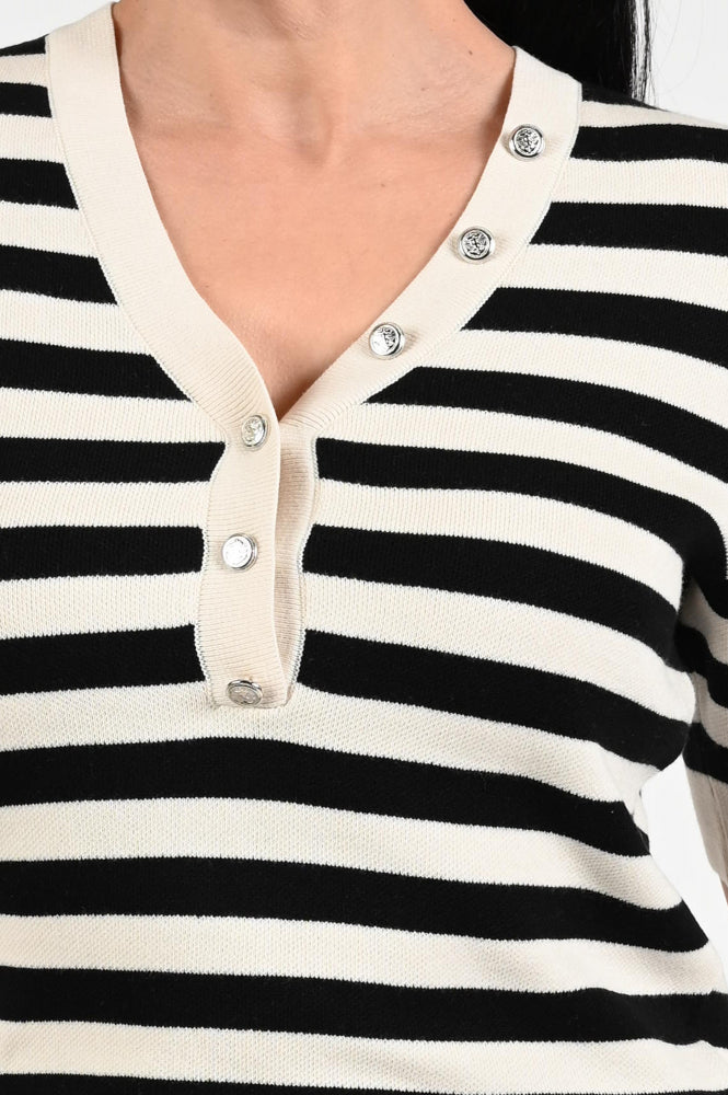Close-up of a black and white striped shirt with buttons.