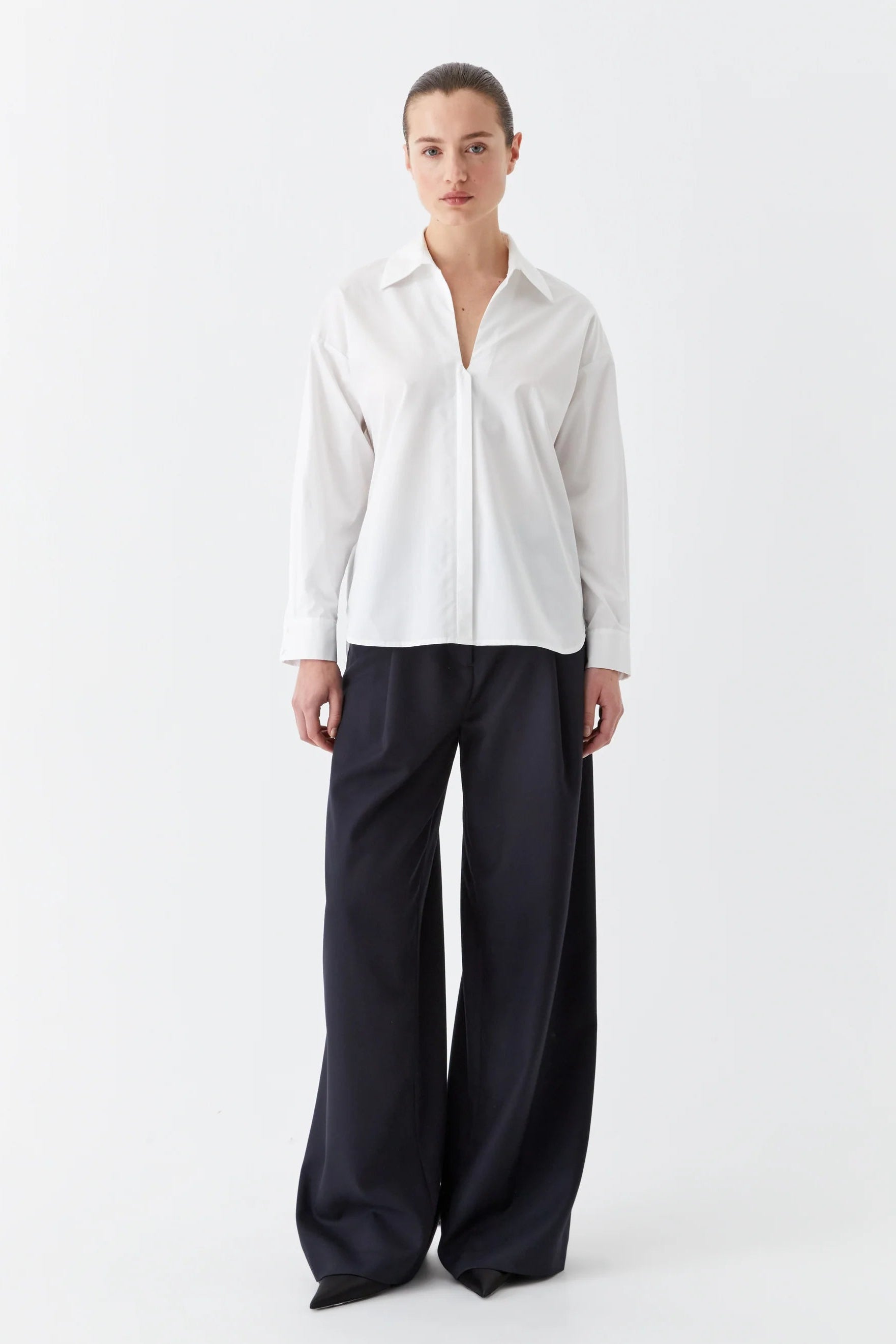 White cotton collared shirt with v neck and back yolk. 