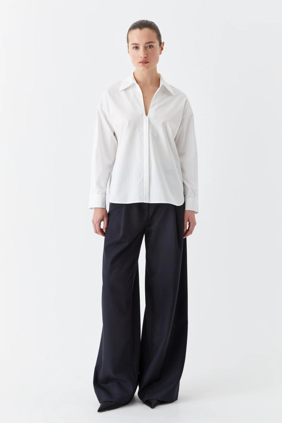White cotton collared shirt with v neck and back yolk. 