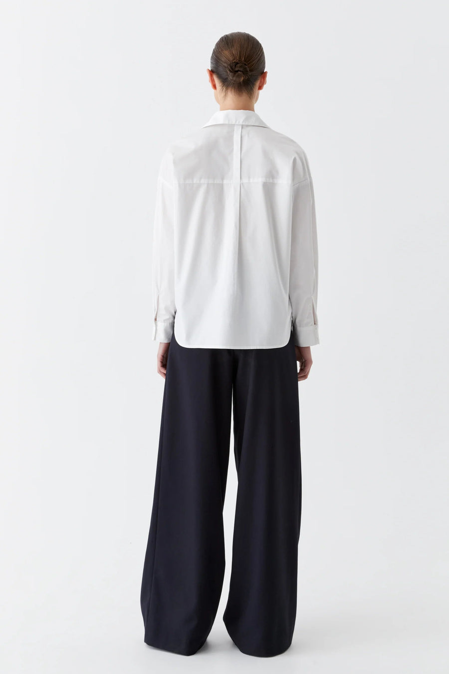 White cotton collared shirt with v neck and back yolk. 