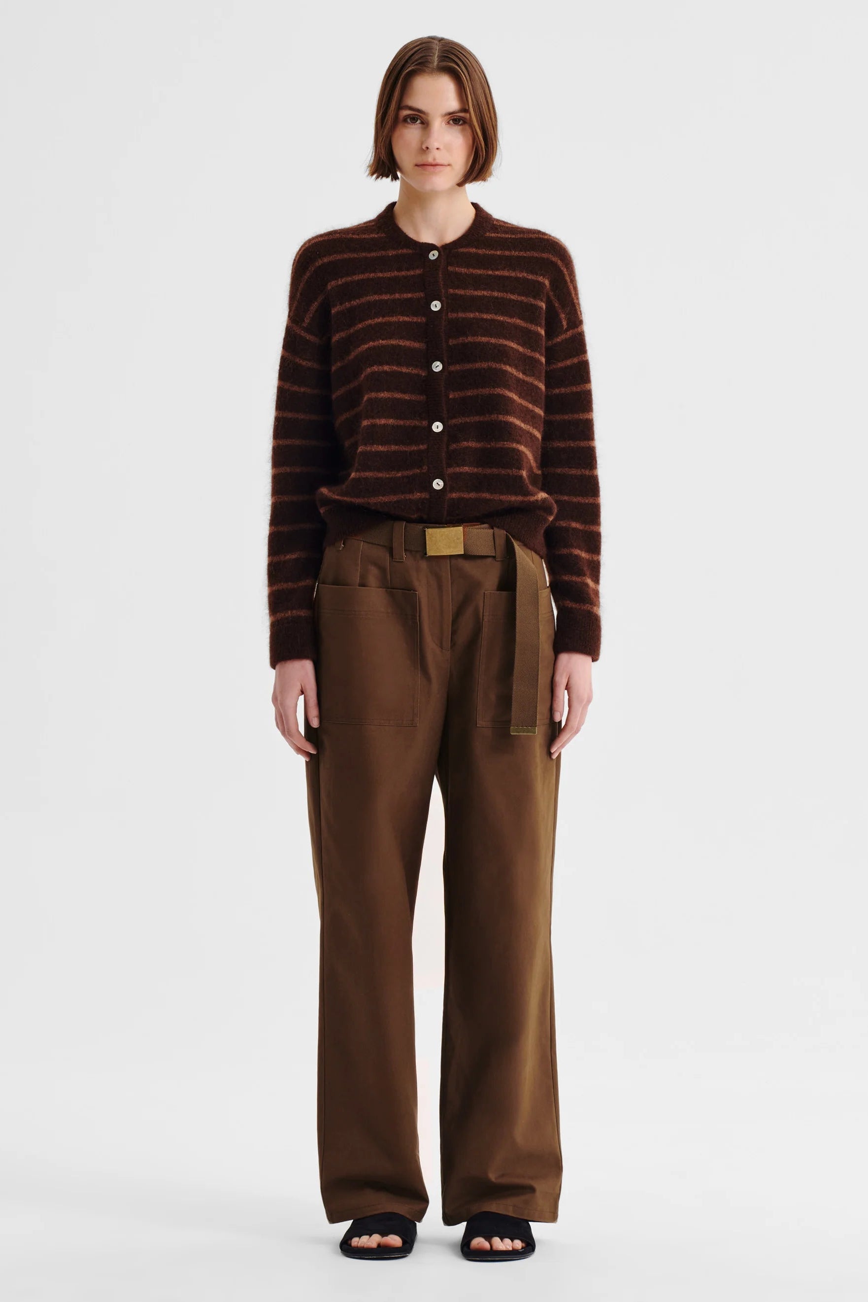 Women wearing stripe knit sweater and nutmeg clouded pant on a white background. 