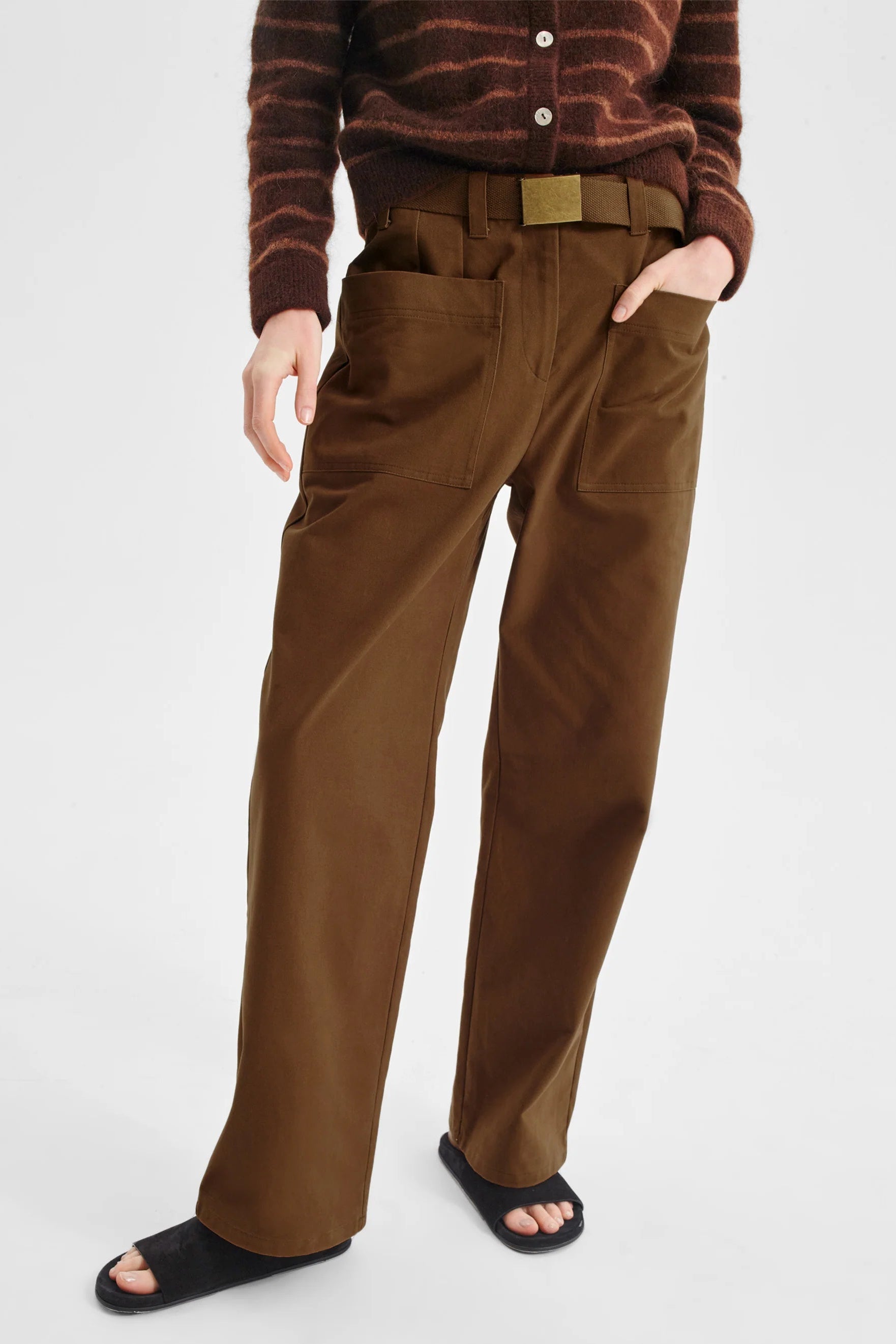 Women wearing stripe knit sweater and nutmeg clouded pant on a white background. 