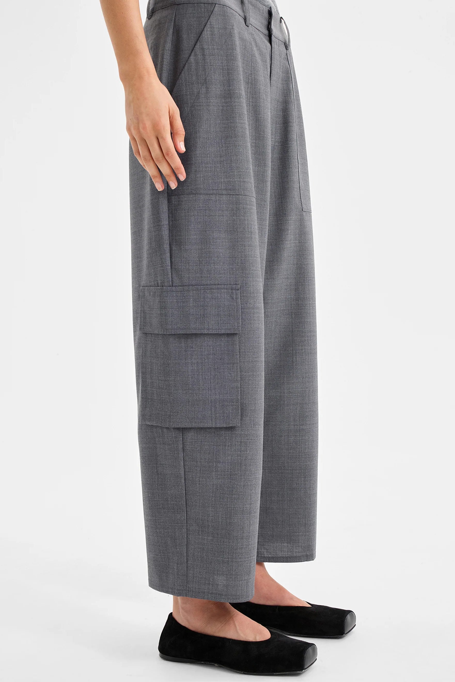 Women wearing charcoal grey cropped cargo pants and matching top on a white background. 