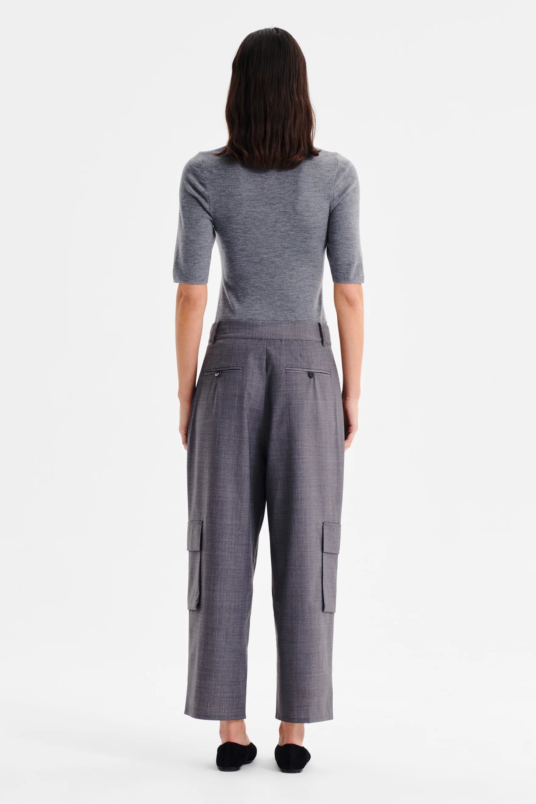 Women wearing charcoal grey cropped cargo pants and matching top on a white background. 