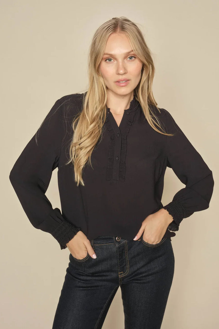 Black long sleeve blouse with frill detail. 