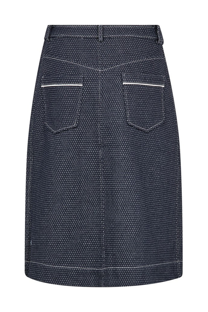 A dark navy blue denim skirt  shown from the. back with a fine white micro-dot pattern, featuring front patch pockets and a button closure at the waistband, shown against a plain white background.