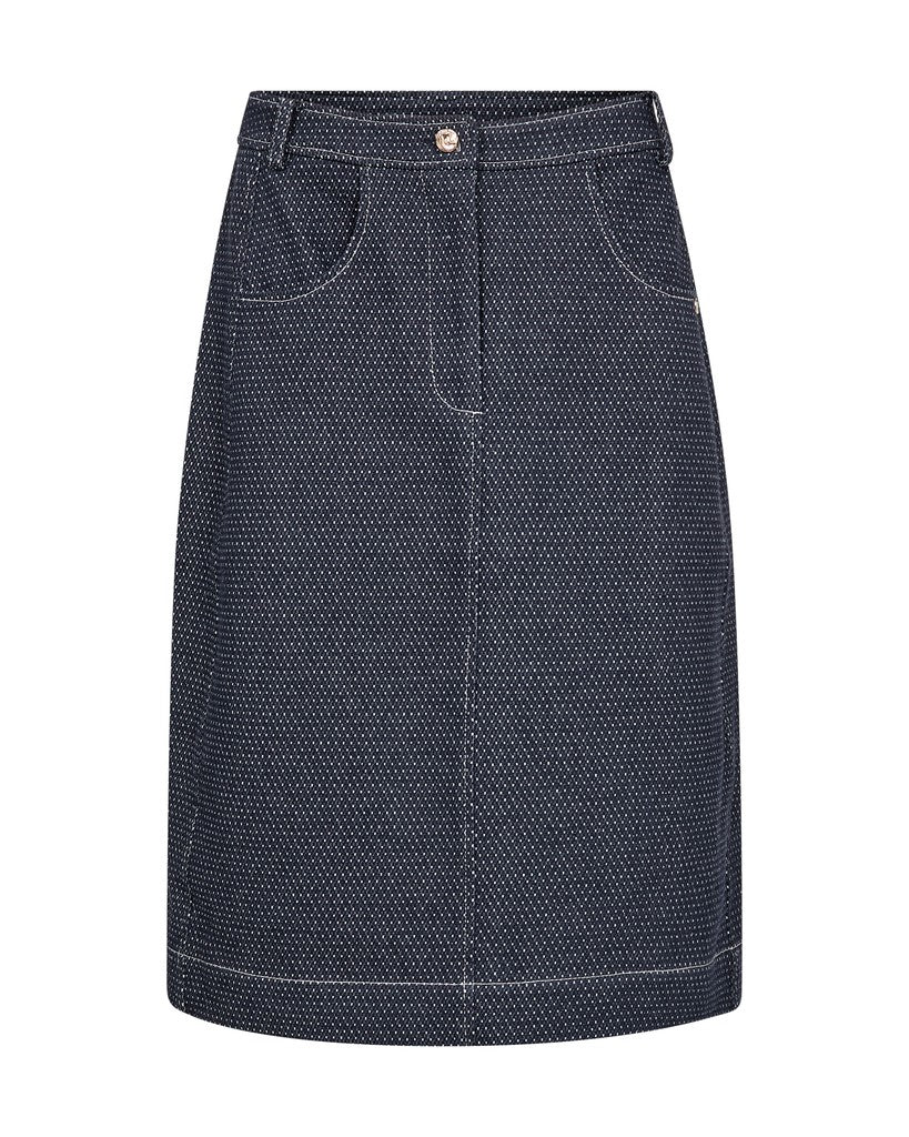A dark navy blue denim skirt with a fine white micro-dot pattern, featuring front patch pockets and a button closure at the waistband, shown against a plain white background.