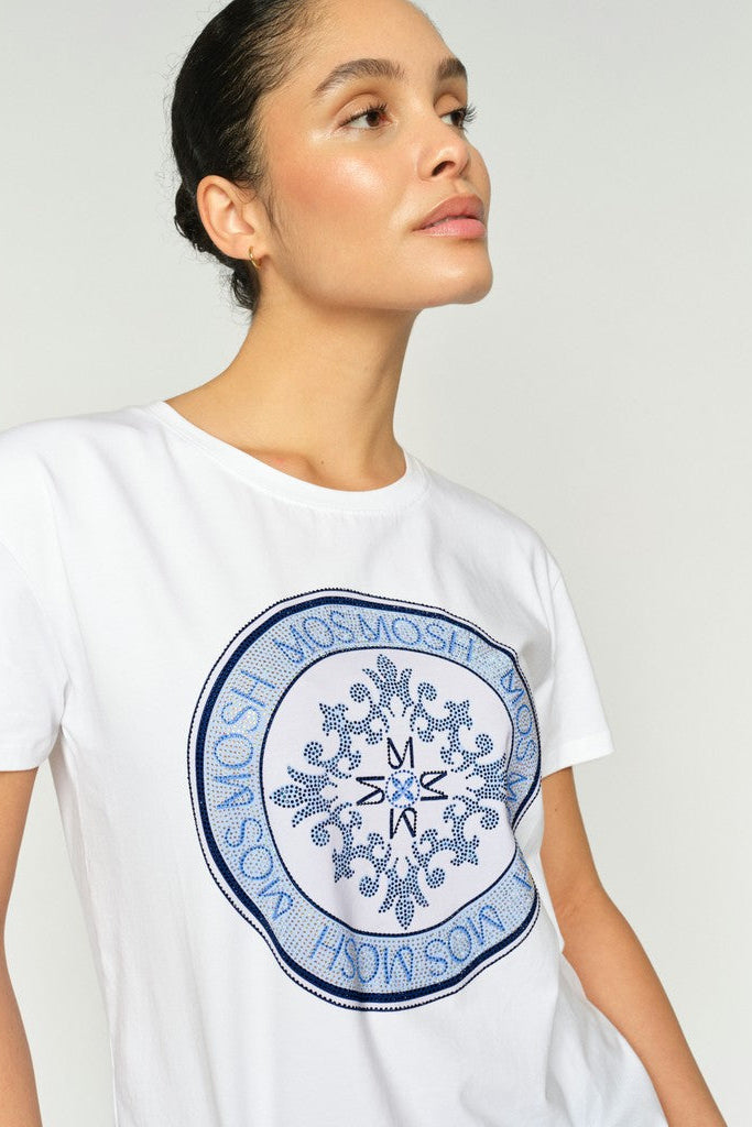 Woman wearing a white t-shirt with a blue logo on a plain background