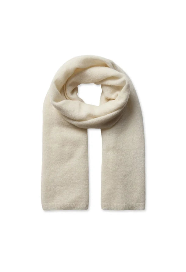 A cream-colored knit scarf, styled in a loop, displayed against a solid white background.