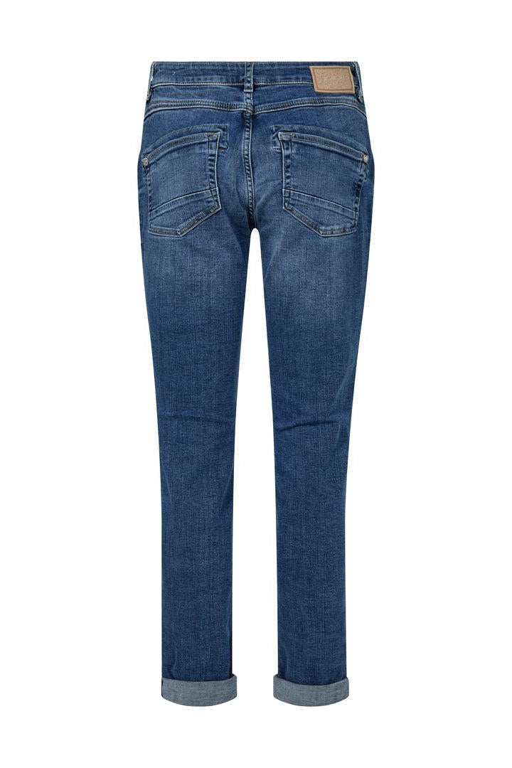 Mid Blue slim leg denim jeans on a white background. 