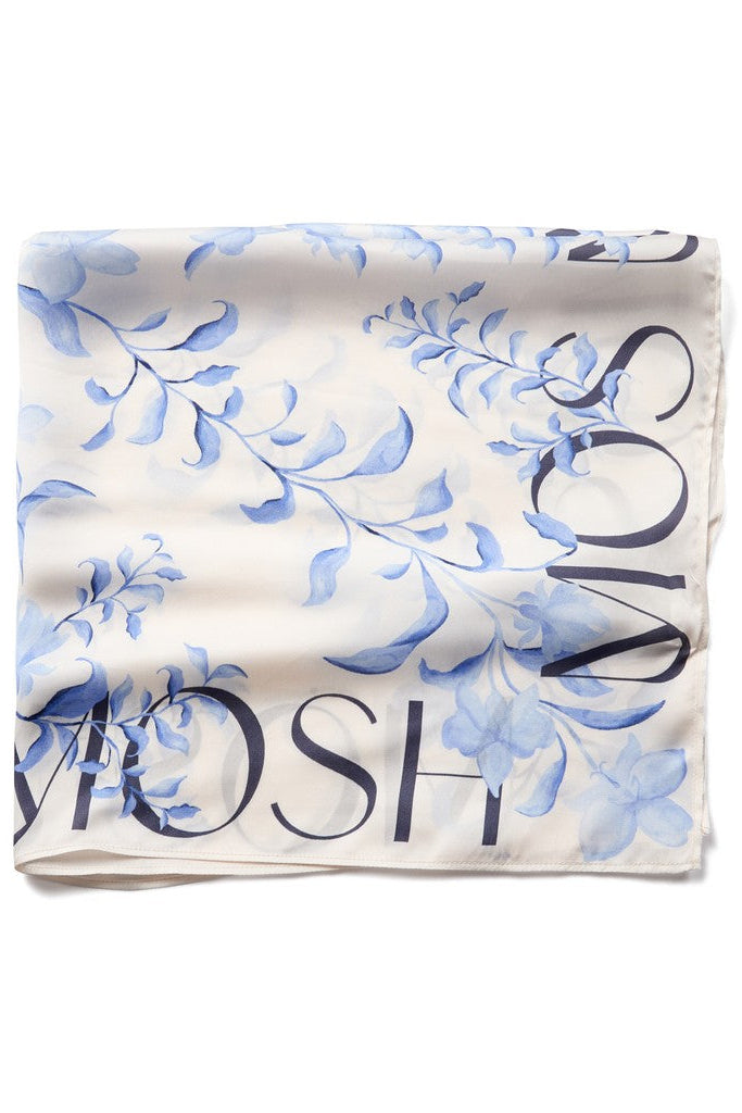 A square scarf featuring a light blue floral pattern on a white background, with 'MOS MOS' printed in dark blue along the borders.