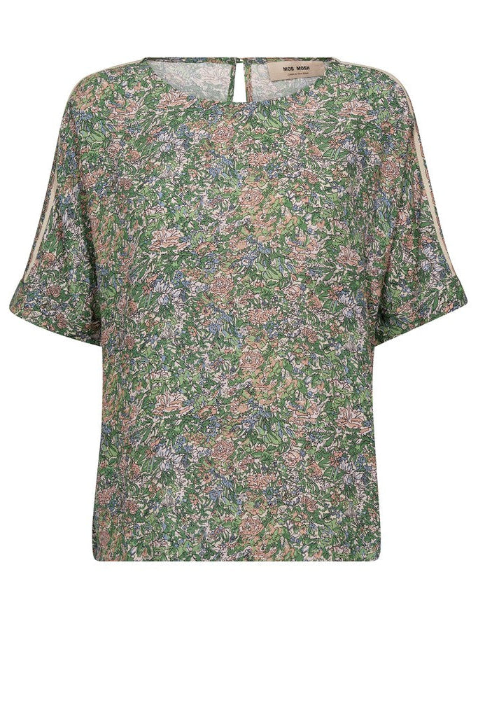 A short-sleeve top with an all-over dense floral print in green, pink, and beige tones, featuring contrasting light beige piping along the shoulder seams and neckline. Shown on a plain background. 