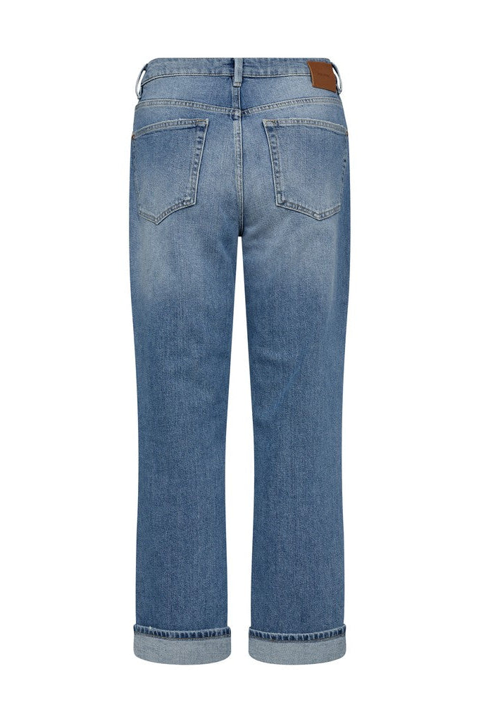 Back view of a pair of medium-wash blue denim jeans with a straight-leg fit, cuffed hems, and a brown leather patch on the back waistband, shown on a plain white background.