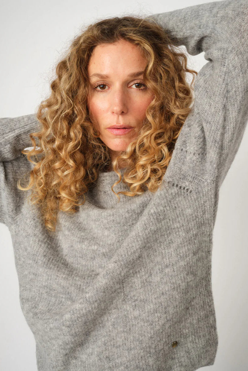 Grey melange crew neck sweater with slight rib detail. Soft alpaca.  