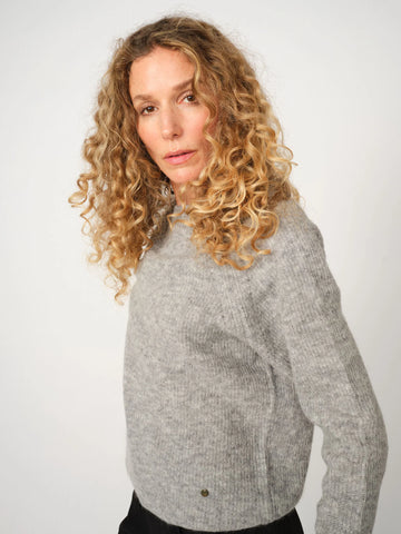 Grey melange crew neck sweater with slight rib detail. Soft alpaca.  