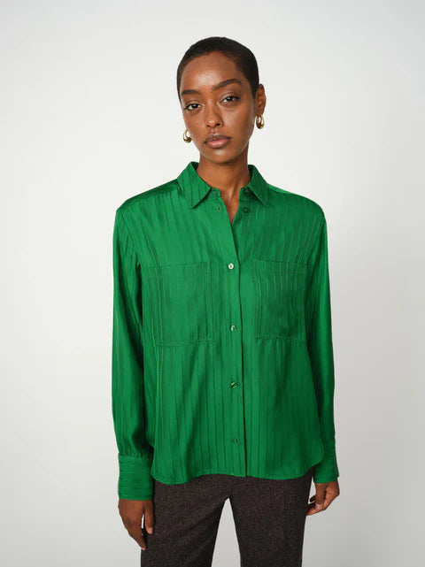 Person wearing a green shirt against a white background