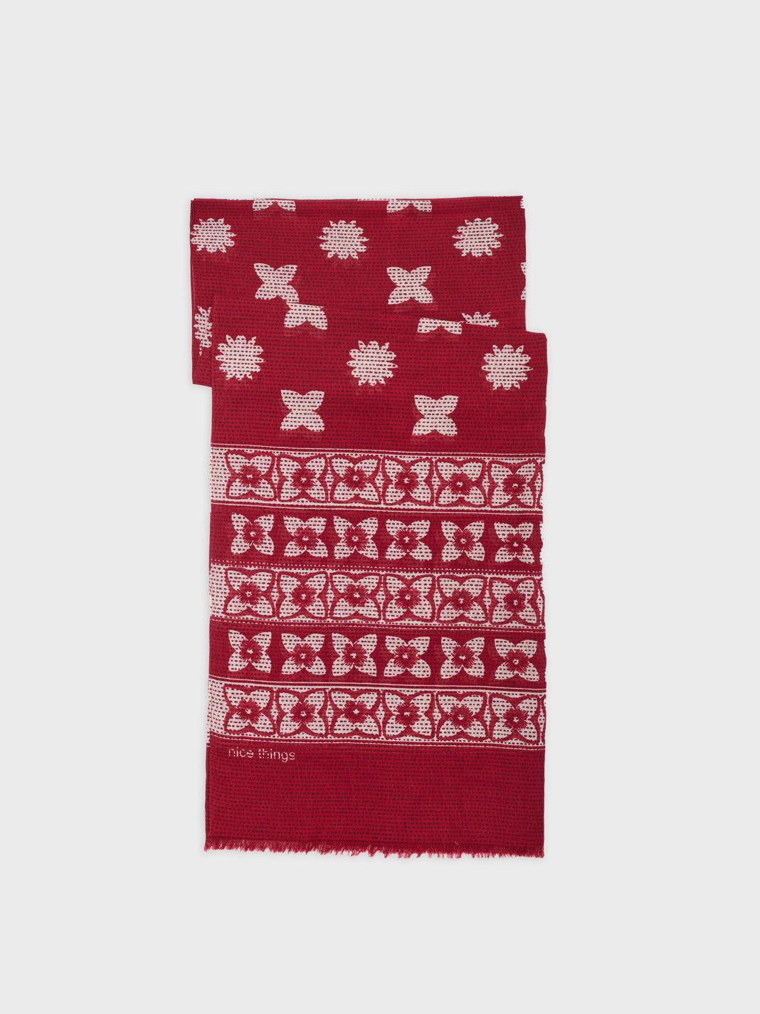 scarf with red base and all over white floral print. 