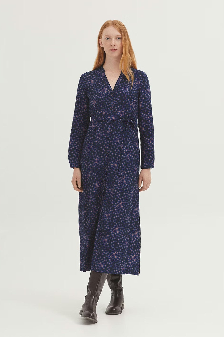 Woman wearing a blue floral dress on a white background