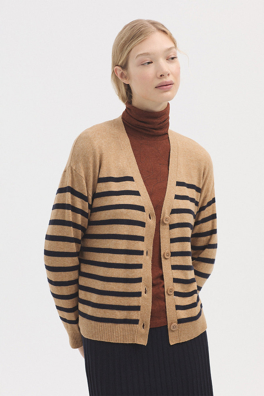 Beige long sleeve cardigan with stripe detail and buttons. 