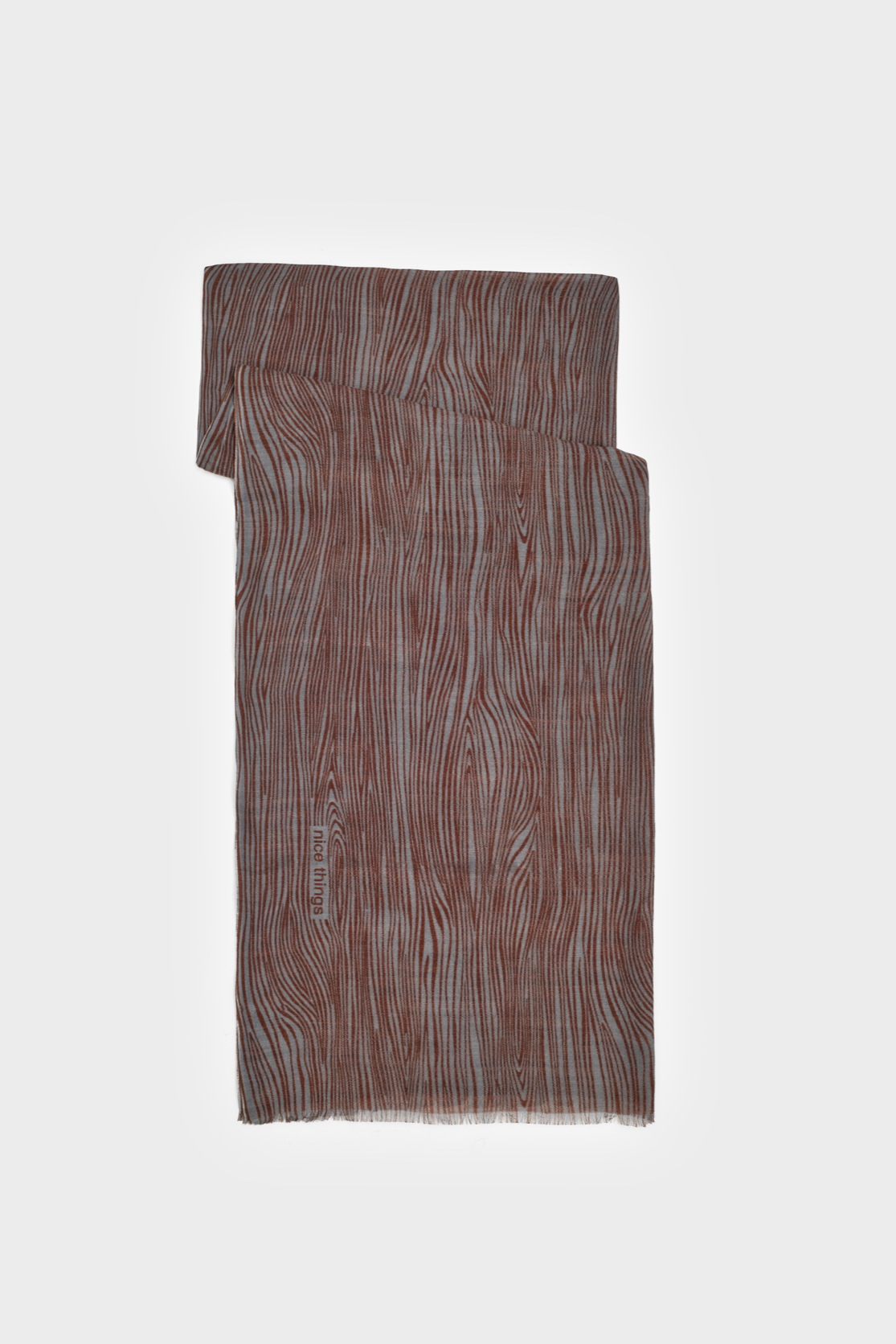 Scarf with grey base and all over terracotta pattern. 