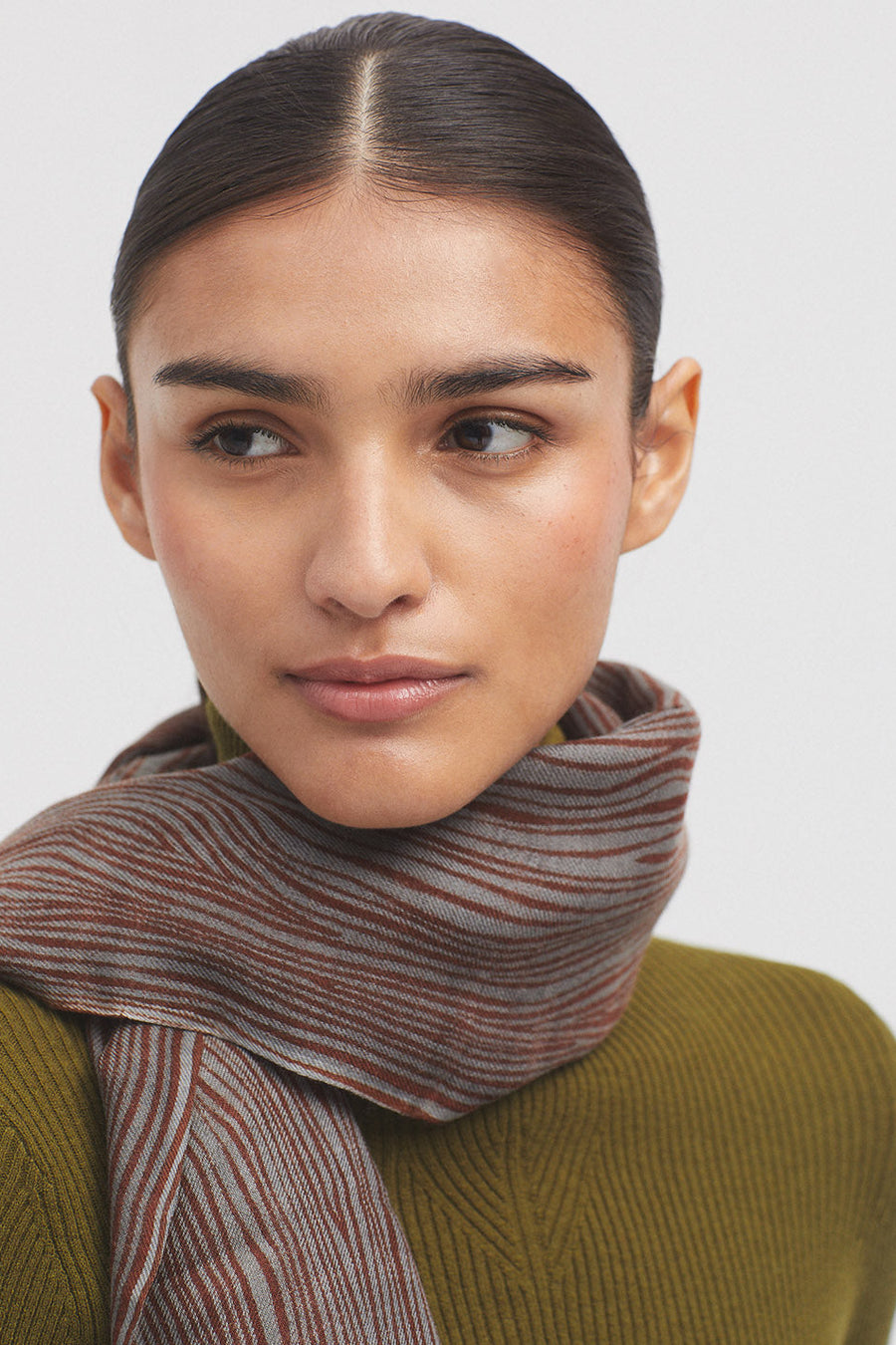 Scarf with grey base and all over terracotta pattern. 