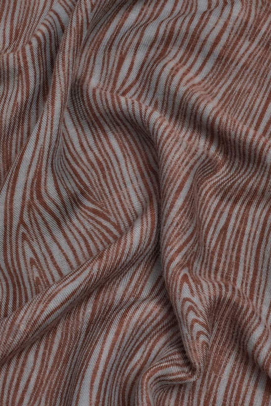 Scarf with grey base and all over terracotta pattern. 