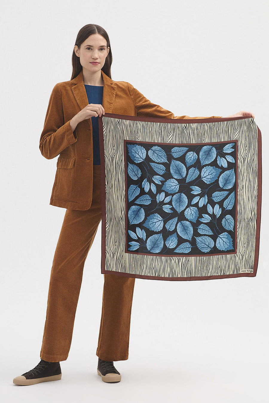 Scarf with all over print in brown and ecru with blue leaves. 