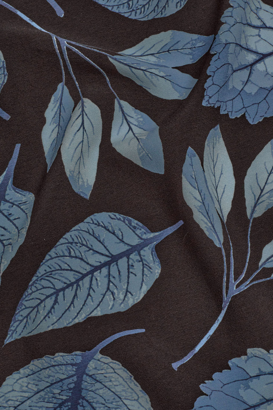 Scarf with all over print in brown and ecru with blue leaves. 