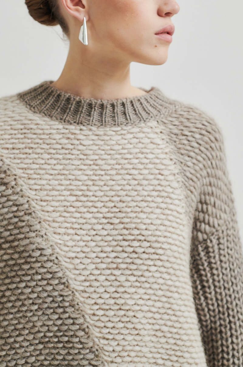 Chunky wool sweater with with a contrast, diagonal panel of lighter-knit fabric,  Cream and Walnut colour with slightly high neck. 