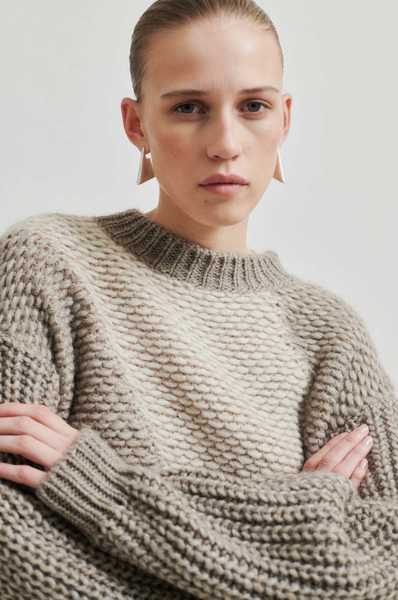 Chunky wool sweater with with a contrast, diagonal panel of lighter-knit fabric,  Cream and Walnut colour with slightly high neck. 