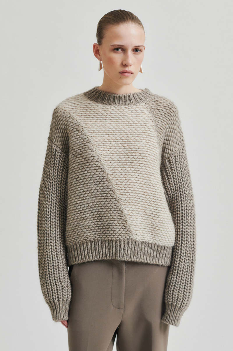 Chunky wool sweater with with a contrast, diagonal panel of lighter-knit fabric,  Cream and Walnut colour with slightly high neck. 