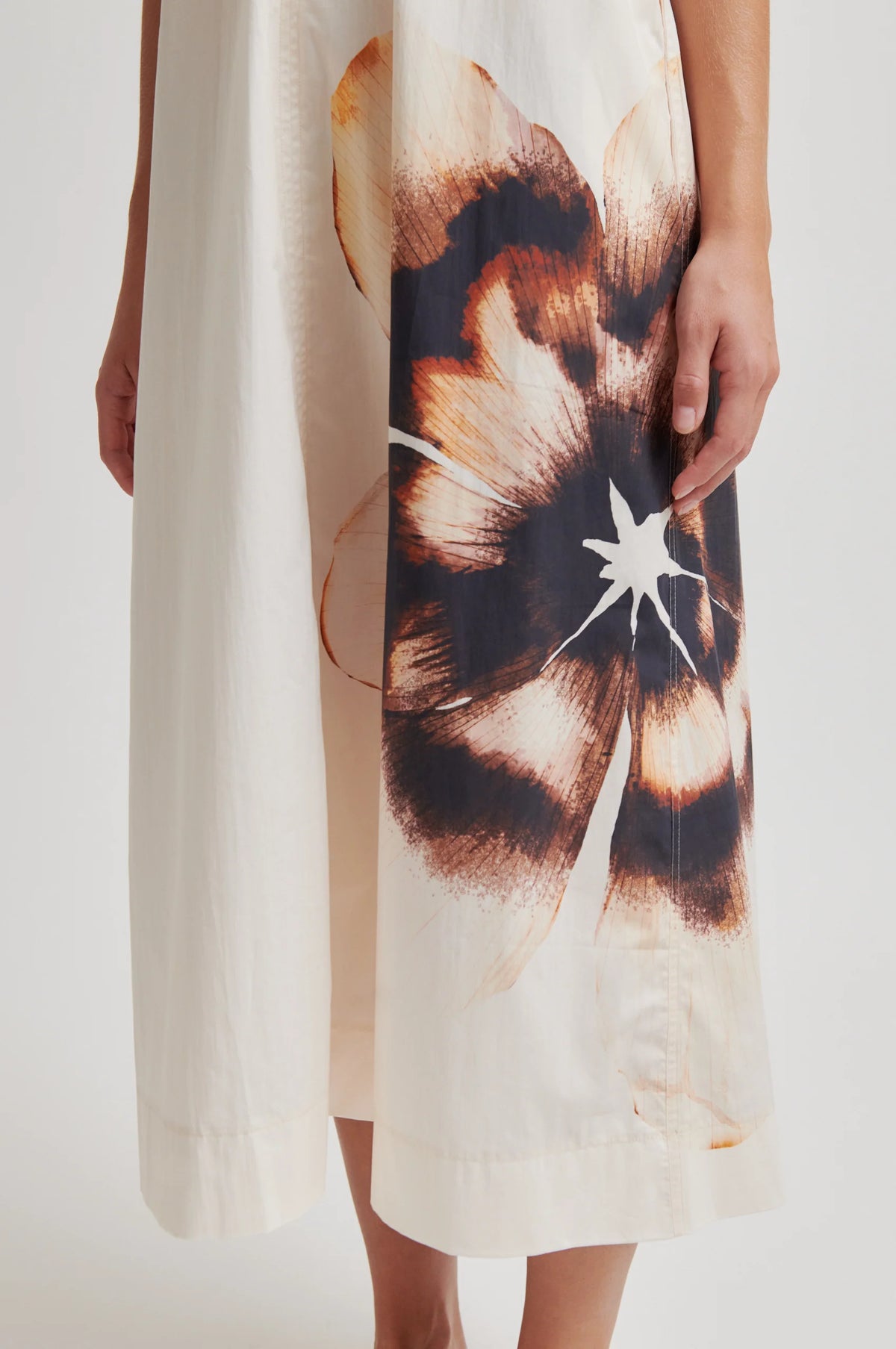 Cream dress with abstract floral design on a plain background