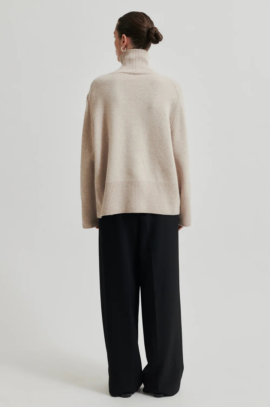 Turtle neck long sleeve sweater in cream. Wide fit back. 