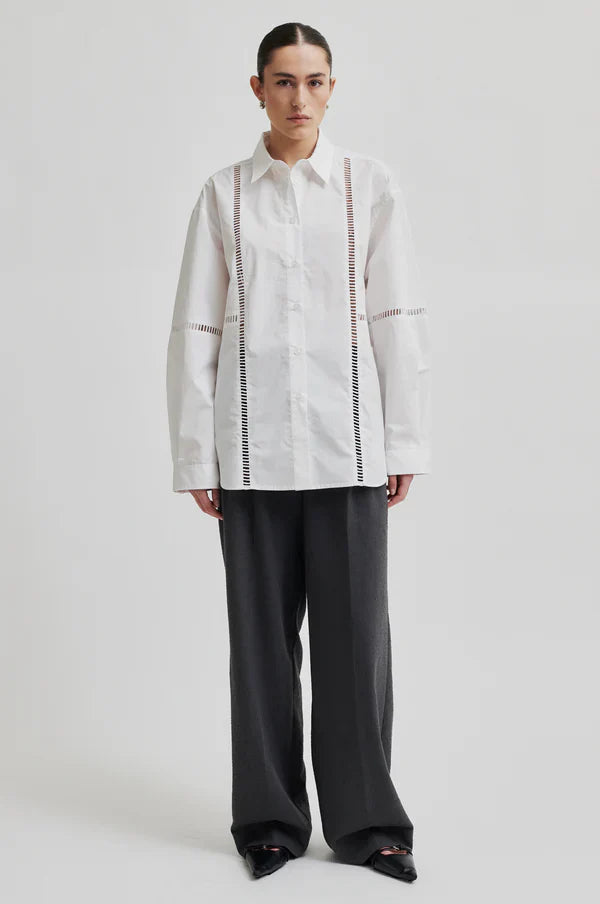 White long sleeve collared shirt with ladder lace detail. 