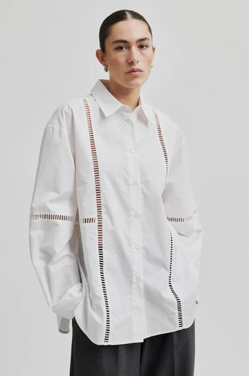 White long sleeve collared shirt with ladder lace detail. 