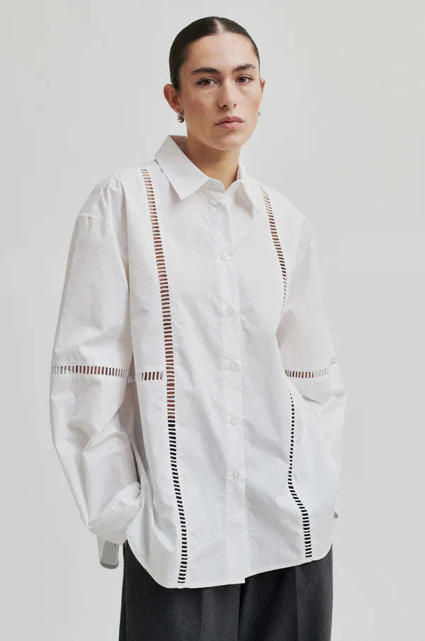 White long sleeve collared shirt with ladder lace detail. 