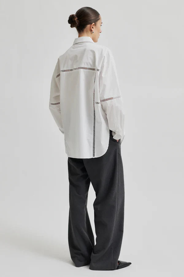 White long sleeve collared shirt with ladder lace detail. 