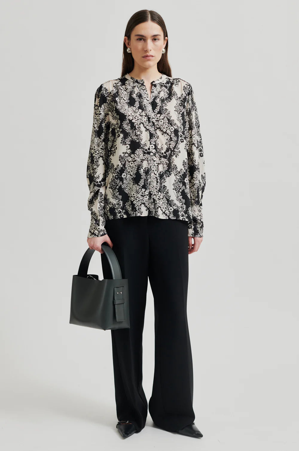 Black and cream floral print shirt with  placket with concealed button fastening and top visible button.